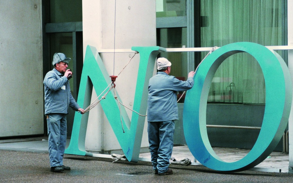 Photograph of the old Novartis logo being changed out -image